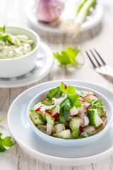 Spring salad with radish, cucumber and avocado