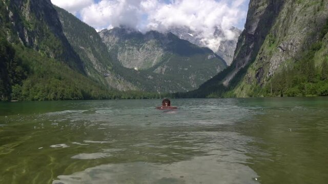 man diving in the water. Obersee, Germany 2020