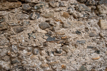 Stone wall background. Cracked wall surface. Design uneven cracked real stone wall surface with cement