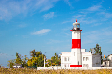Fototapeta na wymiar Beautiful lighthouse on the beach in Berdyansk.