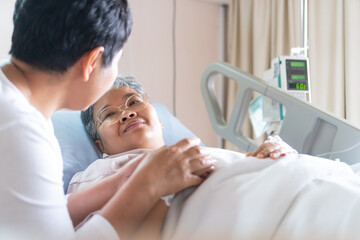 Fototapeta premium Patient Recovering from love family healthy moment.Happy Woman Visits Best friends holding hands for recover, sick lying in Hospital, looking cheerful love hopeful emotional, Encouragement comforting