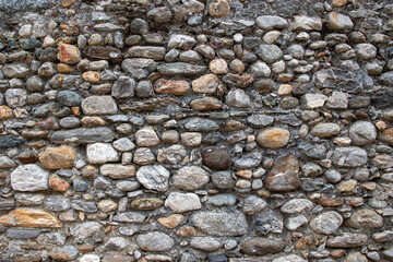 Stone wall background. Cracked wall surface. Design uneven cracked real stone wall surface with cement