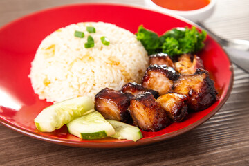 Chinese Sweet Bbq Pork is marinated in a sweet BBQ sauce and served with white rice.