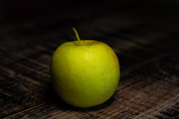 green apple on wooden table