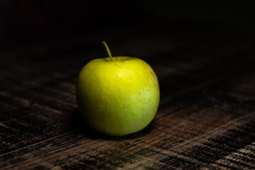green apple on a wooden table