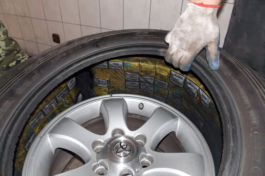 Smilmitsa, Ukraine - October, 2013: Smuggled cigarettes hidden in the spare wheel (reserve tire) of a car crossing the Ukrainian-Polish border at the checkpoint