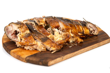 smoked fish, cut into pieces on a wooden cutting board