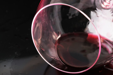 Glass of red dry wine spilled