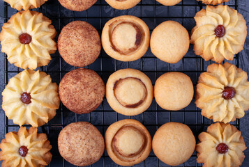 Shortbread cookie assortment on the pastry lattice on the gray wooden table. Top view