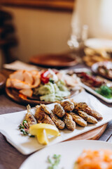 large and generously covered with delicious dishes table, covered with a tablecloth on which there are various delicious dishes of Ukrainian cuisine