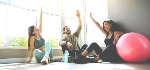 Group of diversity sports people talking and laughing happy together after workout at gym. Healthy Lifestyle and Sport Concepts.