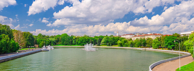 Panorama of Minsk cityscape with Svislach Svislac river embankment; Janka Kupala Park and General Headquarters building in historical centre; blue sky white clouds in sunny day; Republic of Belarus