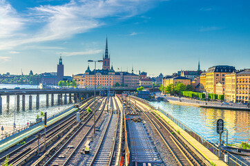 Cityscape of Stockholm historical city centre with Riddarholmen island Church spires, City Hall Stadshuset tower, bridge over Lake Malaren in Gamla Stan and railway subway tracks, Sweden