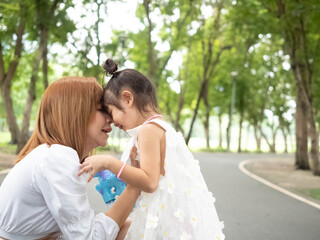 Naklejka premium Outdoor green park.Family mather kid baby child girl portirat are playing hug worm feel emotional romantic together for advertisement insurance happy valentine and birthday congratulation