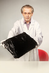 Museologist packing  artifact of emerald tablet to plastic foil