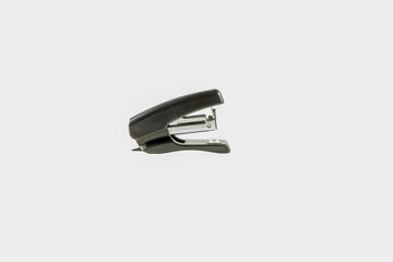 Black stapler. Little. Isolate. Side view