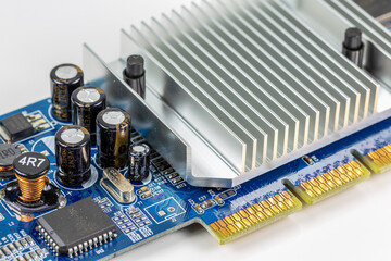 blue circuit board showing on board cooler and electronic components