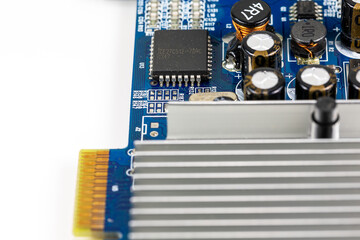 blue circuit board showing on board cooler and electronic components with copy space to the left