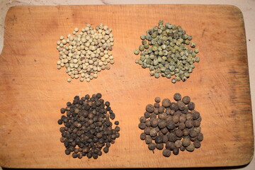 peppercorns green black white Jamaica array over wooden table