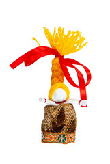 A doll with yellow hair and a red bow. Traditional Russian doll made of fabric. Home crafts.