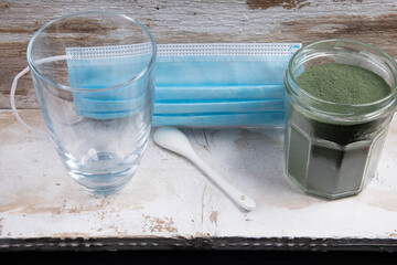 Mouth guard with glass spoon and green superfood powder