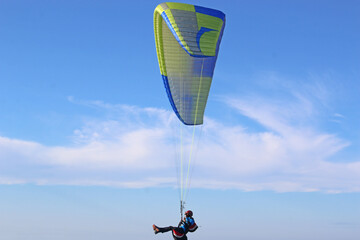 Paraglider flying wing in a blue sky	
