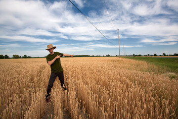 Farmer in Field Pointing
