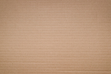 Fototapeta na wymiar Textured yellow cardboard background, soft vignette. Rough backdrop for design