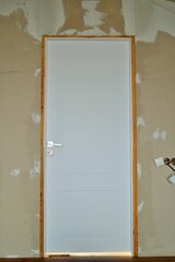 
White door in a renovated room.