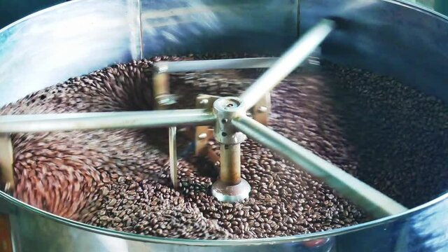 Coffee roaster machine at coffee roasting process.