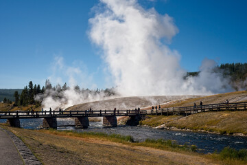Excelsior Geyser erupting by the Firehole River in Yellowstone National Park