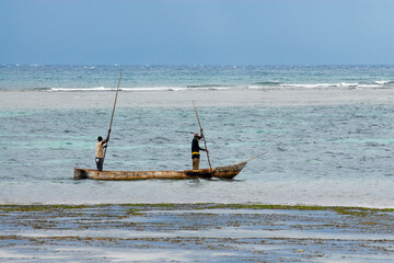Kenyan fishermen in traditional boat in Indian ocean. Surroundings of Mombasa, Kenya.
