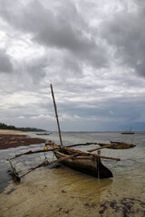 Traditional kenyan fishing boat in Indian ocean on the background of dramatic cloudy skyt....