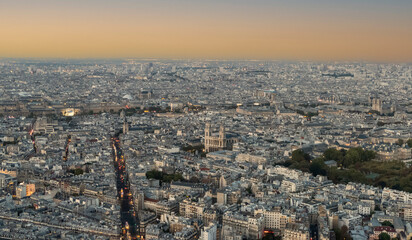 Aerial view of Paris at twilight with the city illuminated