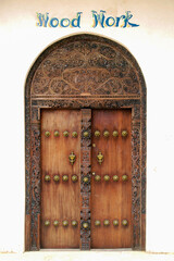 View of traditional door covered with woodcarving. Mombasa, Kenya.
