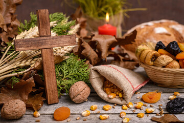 Christmas oak tree, cross, candle, bread and dried fruits