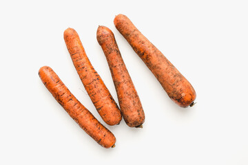 carrots on white background, unwashed carrots
