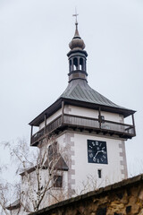 Fototapeta na wymiar Watch stone tower Hlaska with a wooden balustrade, white renaissance building in winter day, Roudnice nad Labem, Central Bohemia, Czech Republic