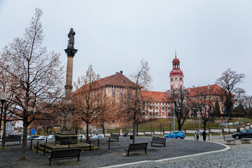 Obraz premium The statue of the Saint Laurel (sv. Vavrince) on the Charles town square (Karlovo namesti) near romantic baroque castle in Roudnice nad Labem, Central Bohemia, Czech Republic