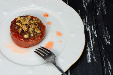 quince dessert with walnuts in a metal plate