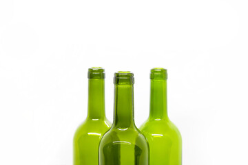 Three green empty wine bottles on a white background