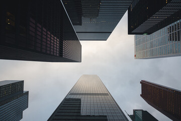 Urban lookup view of tall skyscrapers during sunset in the financial district