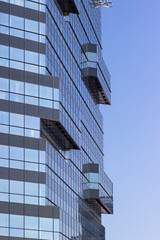 Obraz premium Facade texture of a glass mirrored office building. Fragment of the facade.