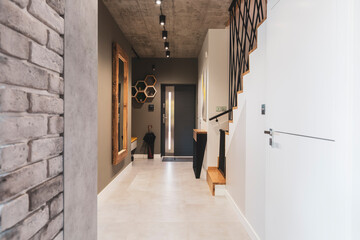 Trendy corridor with big mirror in wooden frame and console table