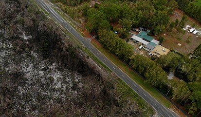A road revents a bushfire from burning a house in New South Wales. Containment lines reinforced by...