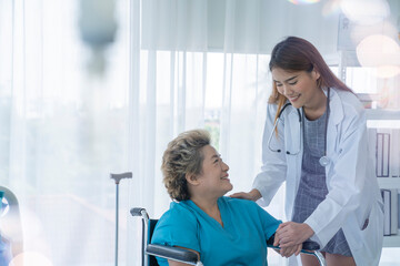 Fototapeta premium asian female doctor and senior patient at hospital