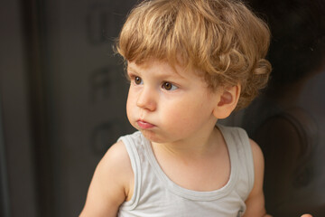 Naklejka premium little child sitting on a floor