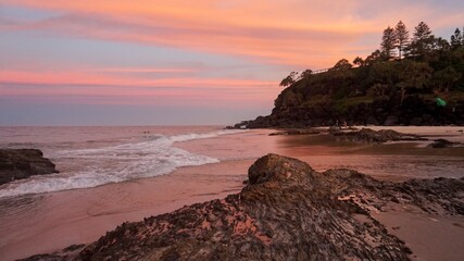 Sunset bathes Froggies beach in orange hues - Gold Coast, Australia