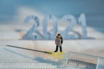 syringe with a men with the text -i like that- and 2021 in the background
