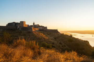 Fototapeta na wymiar Juromenha castle and Guadiana river and border with Spain on the side of the river at sunrise, in Portugal